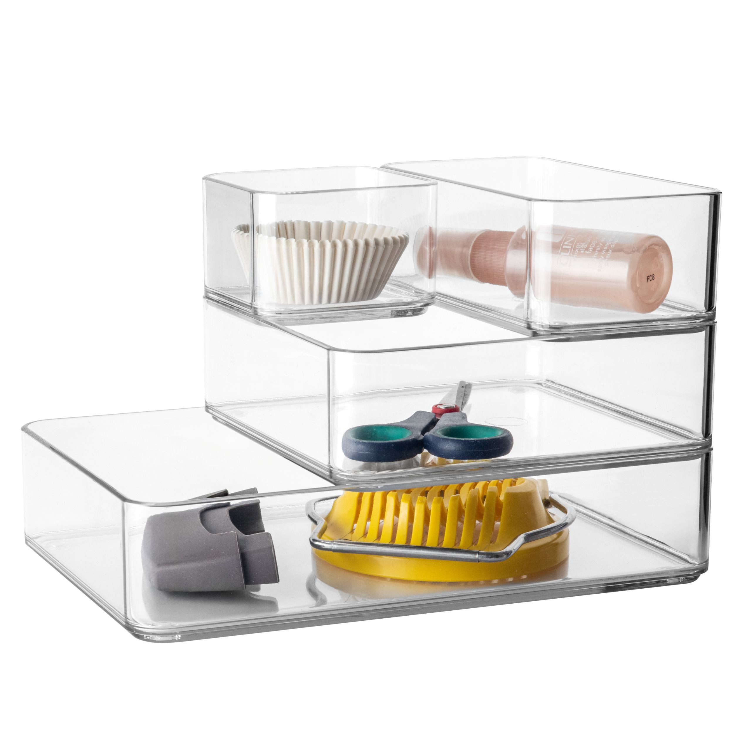 Clear plastic organizes stacked containing office supplies on a white background