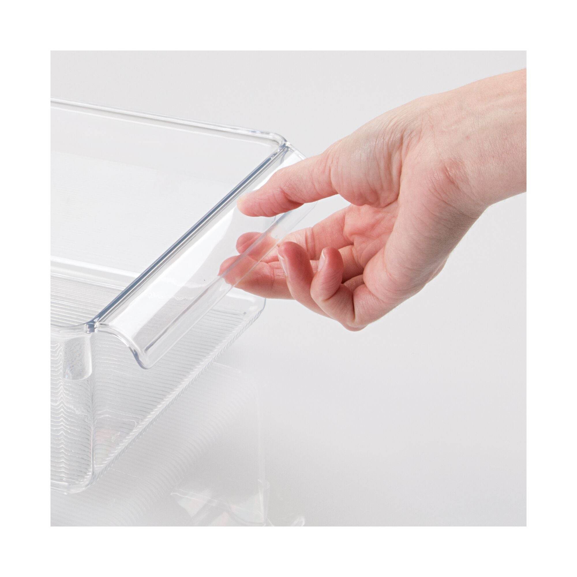 Hand opening a clear plastic container on a white background