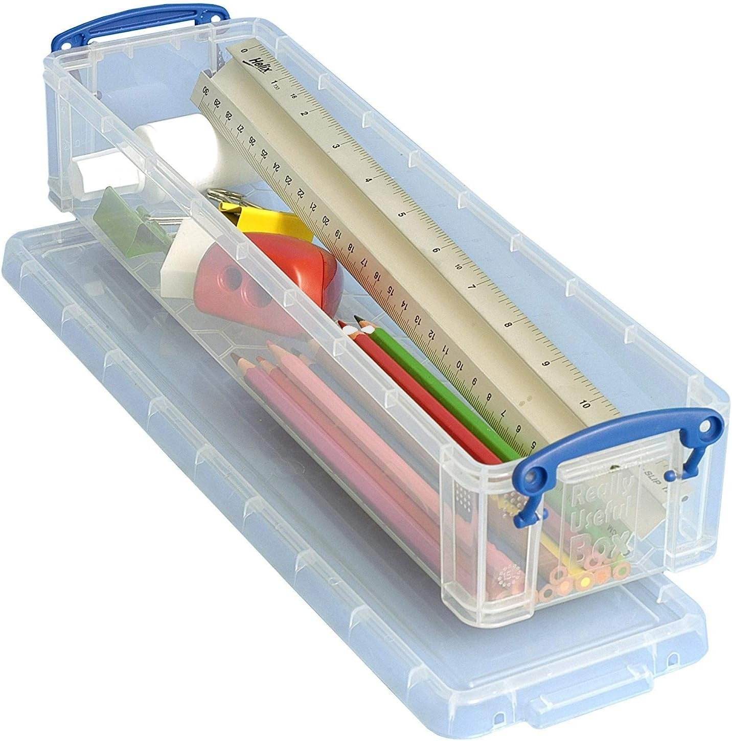 Clear Really Useful storage Box with stationery items including a ruler, pencils, and a tape measure on a white background.