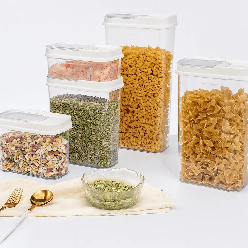 Set of clear food storage containers with various types of pasta on a white background