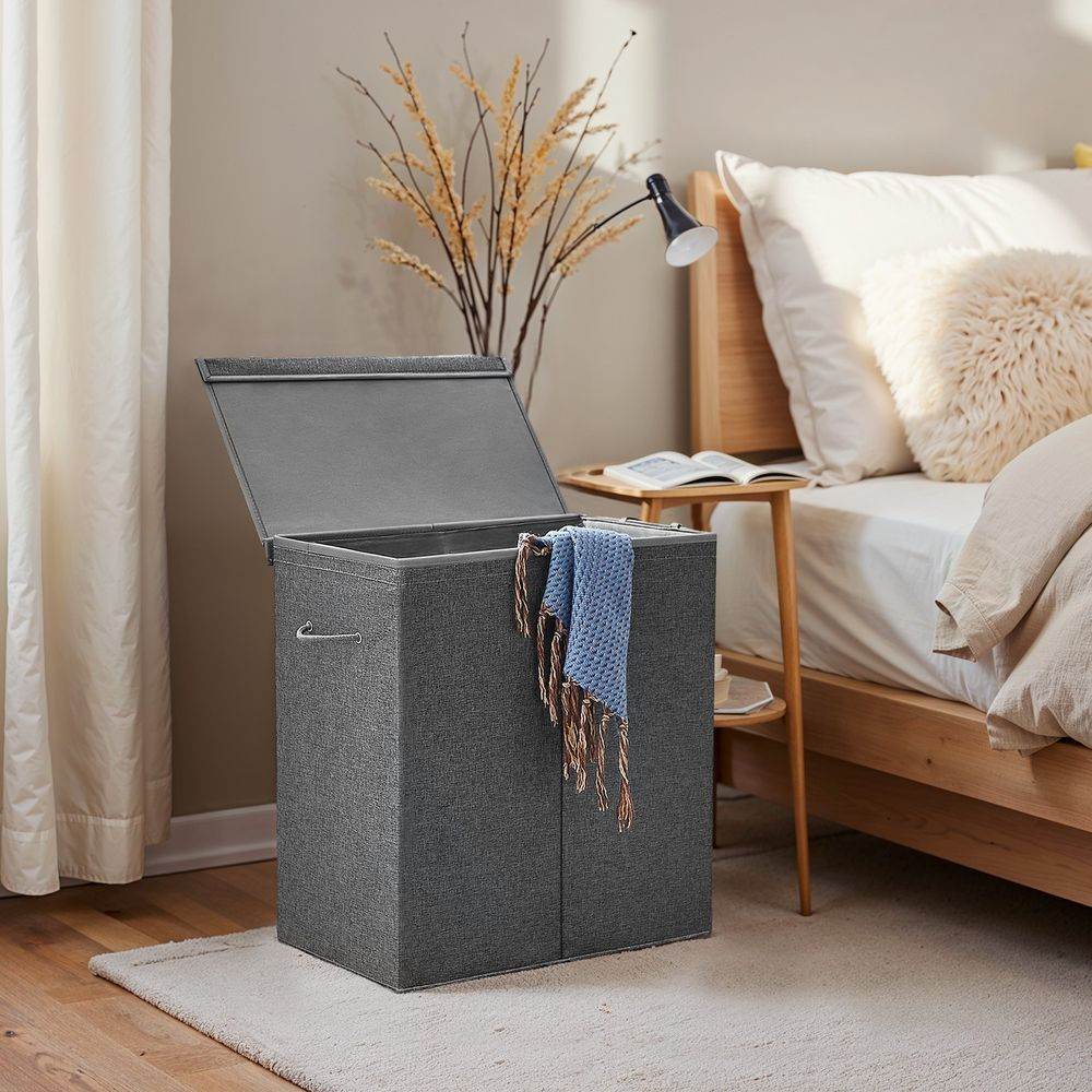 Songmics Laundry Hamper 142L in a bedroom.