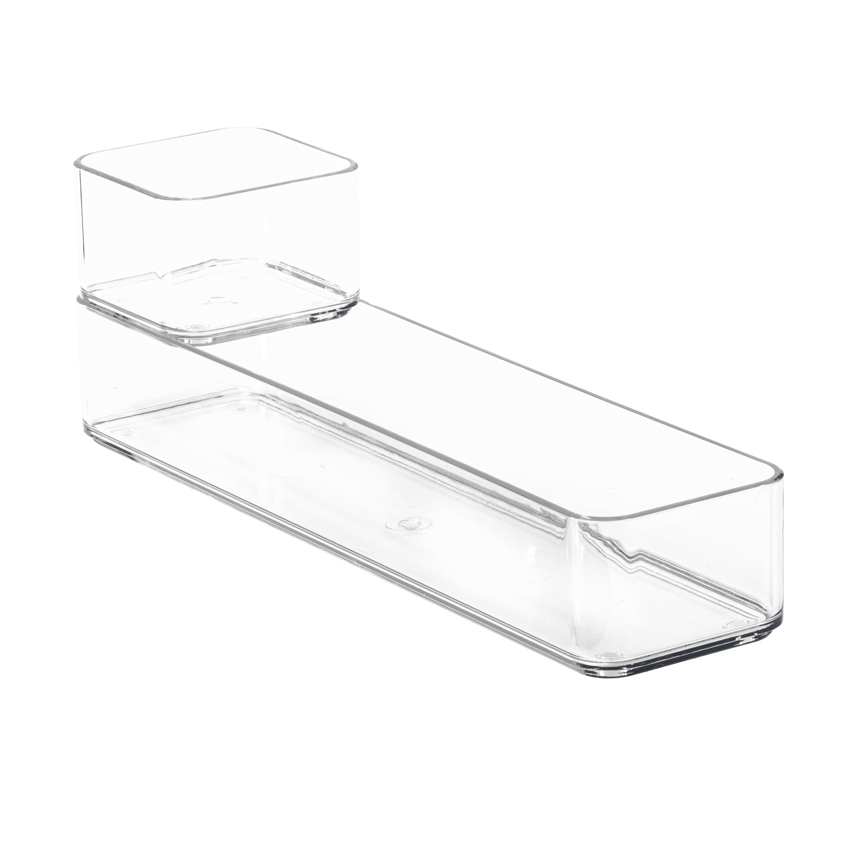 Stackable clear plastic drawer organisers on a white background.
