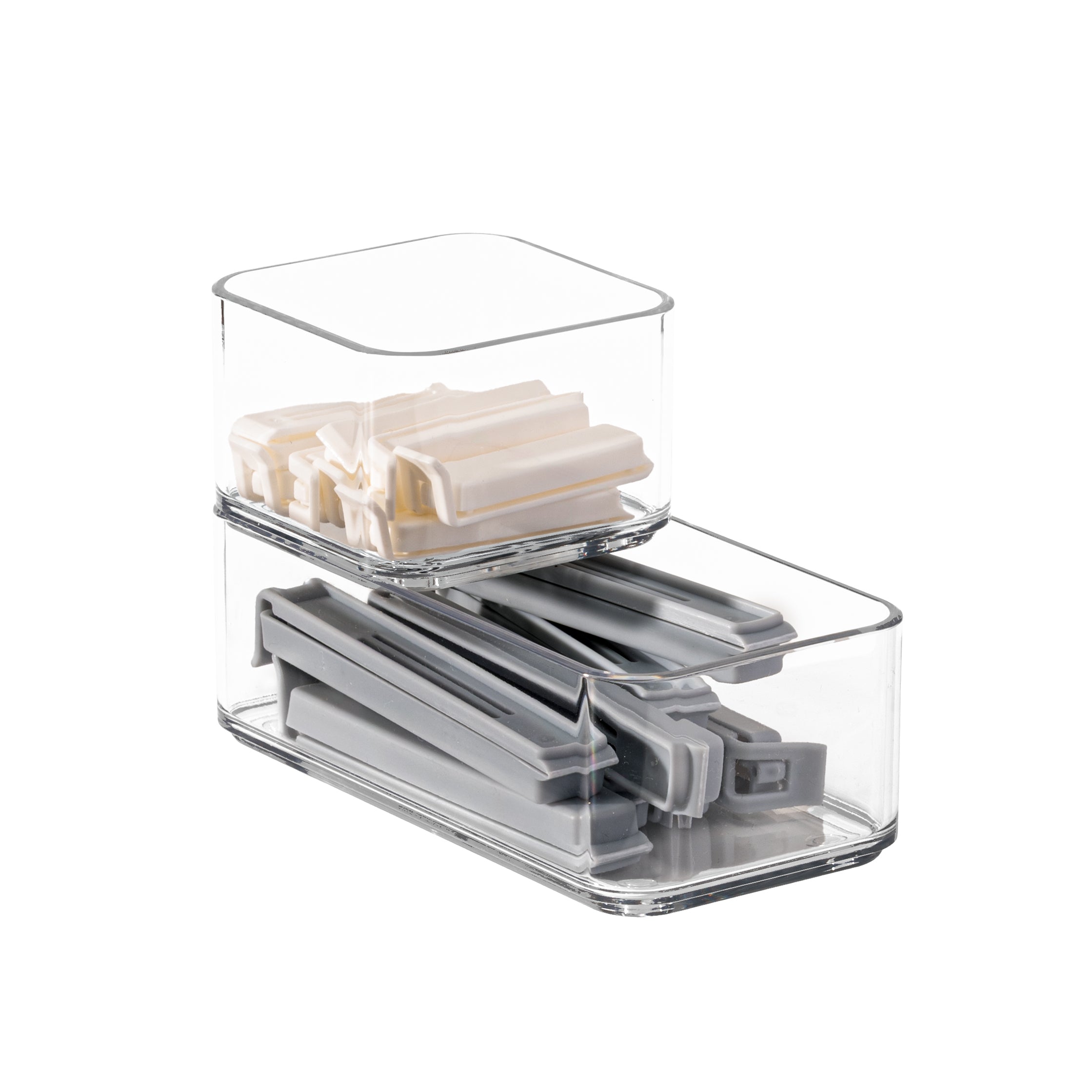Clear plastic organizers stacked on a white background