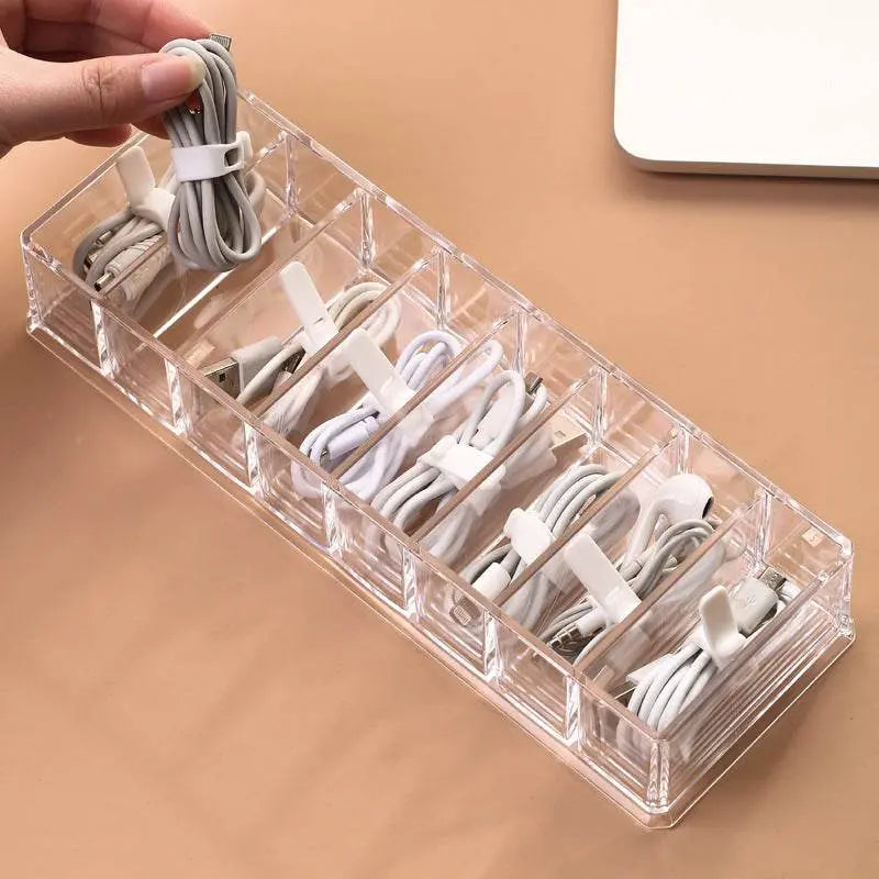 Clear cable organizer with various cables on a beige surface